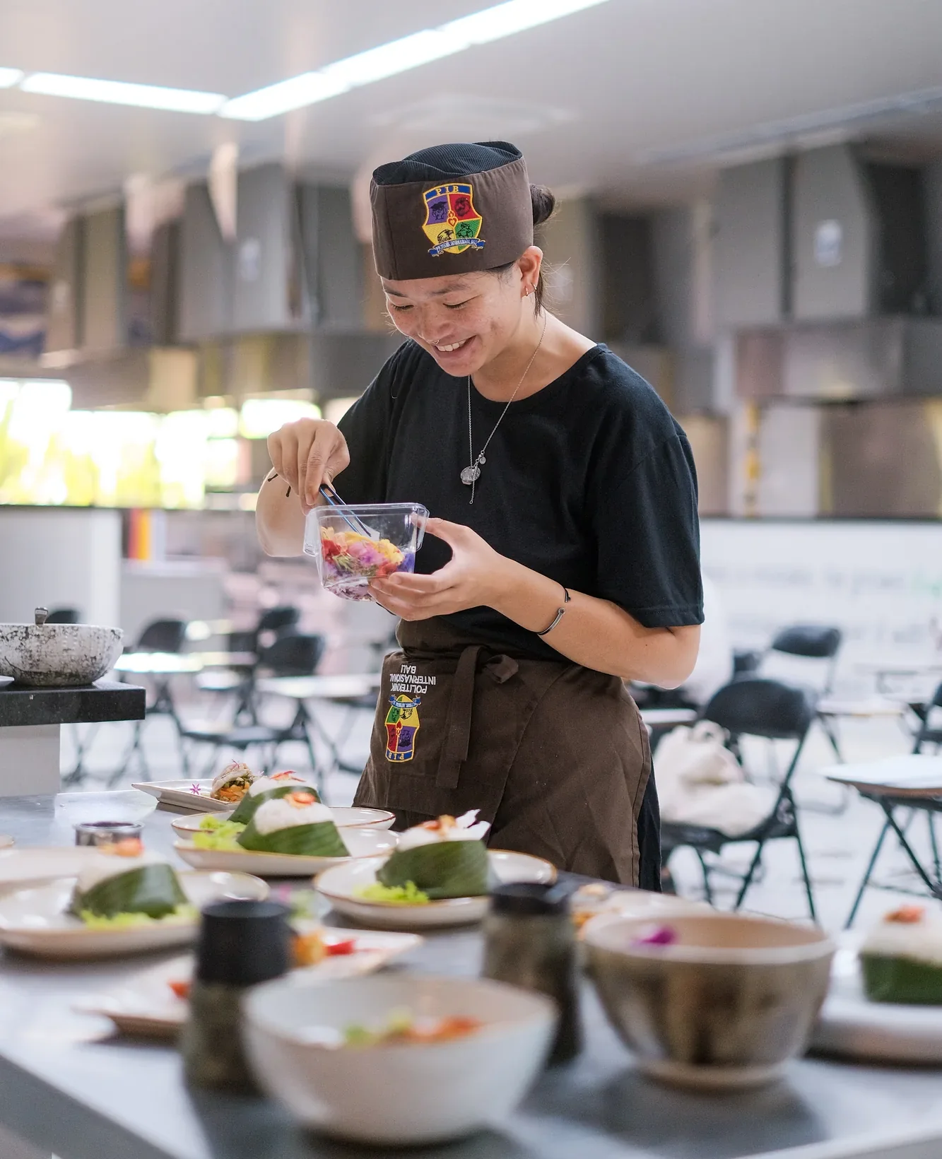 Culinary student tasting a dish in the PIB College teaching kitchen